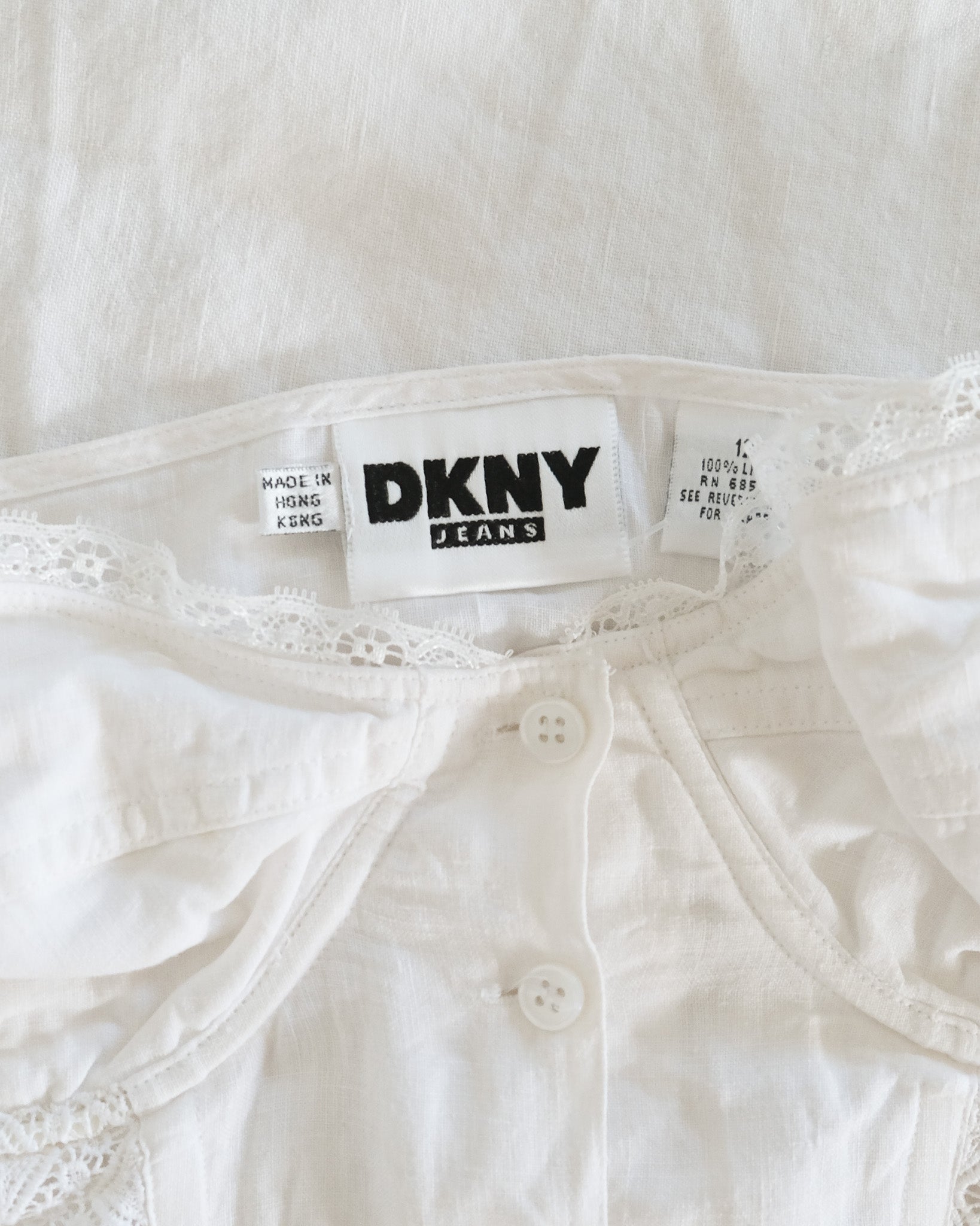 Close-up of DKNY jeans label on a white fabric background
